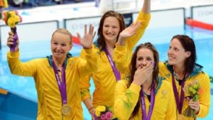 Australias olympic swimming team holds their medals